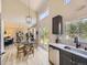 Bright, open floor plan with vaulted ceilings connecting living, dining, and kitchen spaces, featuring modern finishes and ample natural light at 4287 Brookwood Pl, Highlands Ranch, CO 80130