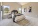 Bright main bedroom featuring neutral tones, a comfortable bed, and windows providing natural light and views of the outdoors at 4287 Brookwood Pl, Highlands Ranch, CO 80130