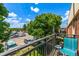 Balcony view overlooking parking lot and a tree under a partly cloudy sky at 5995 W Hampden Ave # 20B, Denver, CO 80227
