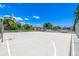 Wide angle view of the community basketball court bordered with chain link fence and picnic tables at 5995 W Hampden Ave # 20B, Denver, CO 80227