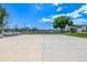 A well-maintained community basketball court with double hoops and a fenced perimeter under a bright blue sky at 5995 W Hampden Ave # 20B, Denver, CO 80227