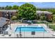 Aerial of the community pool area, nestled between well-maintained apartment buildings with lush landscaping at 5995 W Hampden Ave # 20B, Denver, CO 80227