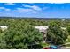 Exterior view showcasing mature trees and lush landscaping surrounding the apartment buildings in the community at 5995 W Hampden Ave # 20B, Denver, CO 80227