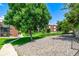 Exterior view of apartment buildings with brick facade surrounded by lush green grass and trees at 5995 W Hampden Ave # 20B, Denver, CO 80227