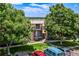 Apartment building featuring a private balcony, with designated parking spaces and surrounded by lush greenery at 5995 W Hampden Ave # 20B, Denver, CO 80227