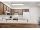Cozy kitchen showcasing wooden cabinets and white appliances with an island at 5995 W Hampden Ave # 20B, Denver, CO 80227
