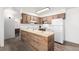 Bright kitchen boasts wooden cabinets and modern appliances and an island at 5995 W Hampden Ave # 20B, Denver, CO 80227