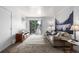 A bright living room featuring a sliding glass door to a balcony with views at 5995 W Hampden Ave # 20B, Denver, CO 80227