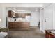 A modern living room flows into a kitchen with modern cabinets at 5995 W Hampden Ave # 20B, Denver, CO 80227