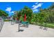 Community picnic area featuring green picnic tables with red umbrellas and bike racks at 5995 W Hampden Ave # 20B, Denver, CO 80227