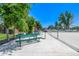 Community picnic area featuring green picnic tables and benches near a chain link fence at 5995 W Hampden Ave # 20B, Denver, CO 80227