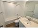 Bathroom with a soaking tub and shower combo, a vanity with quartz countertop, and a large mirror at 8205 Rockvale Dr, Littleton, CO 80125