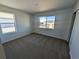 Bright bedroom featuring carpet floors, a large window and neutral color palette at 8205 Rockvale Dr, Littleton, CO 80125