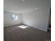 Spacious carpeted bedroom with large windows and a neutral color palette ready for customization at 8205 Rockvale Dr, Littleton, CO 80125