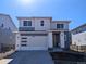 Charming two-story home with a two-car garage, modern design, and a well-lit entrance at 8205 Rockvale Dr, Littleton, CO 80125