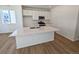 Bright kitchen features a large island with quartz countertop, stainless steel appliances, and hardwood floors at 8205 Rockvale Dr, Littleton, CO 80125