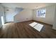 Bright living room featuring hardwood floors, a large window and easy access to the upper floors at 8205 Rockvale Dr, Littleton, CO 80125