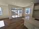 Open floor plan living room with hardwood floors, large sliding glass doors, and lots of natural light at 8205 Rockvale Dr, Littleton, CO 80125