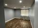 Spacious bedroom with wood-style flooring, neutral walls, and window coverings for added privacy at 2441 S Xanadu Way # A, Aurora, CO 80014