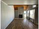 Open living area with beamed ceilings, tile fireplace, and built-in shelving for style and function at 2441 S Xanadu Way # A, Aurora, CO 80014