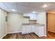 Basement kitchenette with white cabinets and a sink, perfect for entertaining at 13871 Ivy St, Thornton, CO 80602