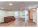 Spacious finished basement with wood flooring, kitchenette, and comfortable seating area at 13871 Ivy St, Thornton, CO 80602