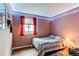 Comfortable bedroom with accent lighting, window with red curtains, and wood flooring at 13871 Ivy St, Thornton, CO 80602