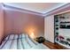 Well-lit bedroom featuring a closet with open shelving and a comfortable bed at 13871 Ivy St, Thornton, CO 80602