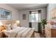 Stylized bedroom with wood floors, window views, and neutral decor at 13871 Ivy St, Thornton, CO 80602