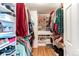 A well-organized walk-in closet with built-in shelving and ample hanging space for clothing and shoes at 13871 Ivy St, Thornton, CO 80602