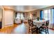 Formal dining area filled with natural light, with laminate flooring and table for six at 13871 Ivy St, Thornton, CO 80602