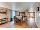 Inviting dining area features hardwood floors and natural light from the adjacent windows at 13871 Ivy St, Thornton, CO 80602
