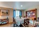 Bright dining room with laminate floors, table for six, and an interesting built-in china cabinet at 13871 Ivy St, Thornton, CO 80602