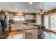 Bright kitchen with stainless steel appliances, white cabinets, and a breakfast bar with seating at 13871 Ivy St, Thornton, CO 80602