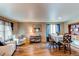 Inviting living and dining space with laminate floors, and lots of natural light from large windows at 13871 Ivy St, Thornton, CO 80602