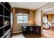 Bright office space with built-in shelving, a work desk, and natural light from a large window at 13871 Ivy St, Thornton, CO 80602