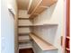 Walk-in pantry with wood shelving providing ample storage space at 13871 Ivy St, Thornton, CO 80602