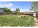 Large, grassy backyard with wood fence and table at 741 Quitman St, Denver, CO 80204