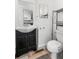 Bathroom featuring black vanity, toilet and accent mirror at 741 Quitman St, Denver, CO 80204