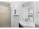 Bathroom with glass-enclosed shower and black vanity at 741 Quitman St, Denver, CO 80204