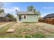 Charming single-story home featuring light green siding, a welcoming front door, and a compact yard at 741 Quitman St, Denver, CO 80204