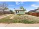 Charming single-story home featuring light green siding, a welcoming front door, and a compact yard at 741 Quitman St, Denver, CO 80204