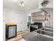 Efficient kitchen with white cabinets, dark countertops, and appliances, enhanced by gray flooring at 741 Quitman St, Denver, CO 80204