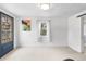 Bright living room with hardwood floors, a large window, and blue entry door at 741 Quitman St, Denver, CO 80204
