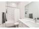 Clean and modern bathroom with white subway tiles, a shower-tub combo, and sleek vanity at 3880 W 13Th Ave, Denver, CO 80204
