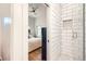 Modern bathroom with white subway tile shower, black accents, and sleek fixtures at 3880 W 13Th Ave, Denver, CO 80204