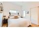 Bright bedroom featuring light hardwood floors and a comfortable bed with a soft, textured comforter at 3880 W 13Th Ave, Denver, CO 80204