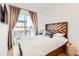 Bedroom with a sliding glass door, modern headboard, and stylish curtains for natural light at 3880 W 13Th Ave, Denver, CO 80204