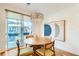 Bright dining area with modern lighting, neutral color palette, and large windows at 3880 W 13Th Ave, Denver, CO 80204