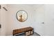 Inviting foyer with a leather bench, coat rack, and stylish round mirror at 3880 W 13Th Ave, Denver, CO 80204